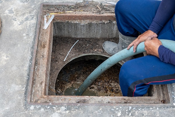 slow drainage, foul odors, and visible grease accumulation in the trap are all signs that grease trap pumping is needed